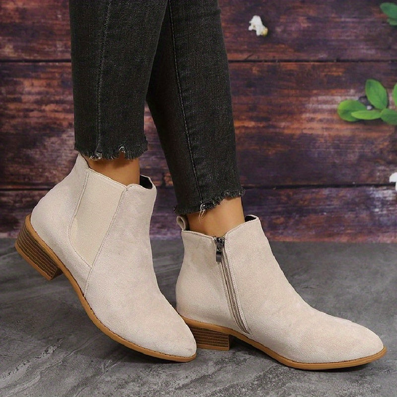 Light beige suede ankle boots with elastic side panels and low stacked heel, pair