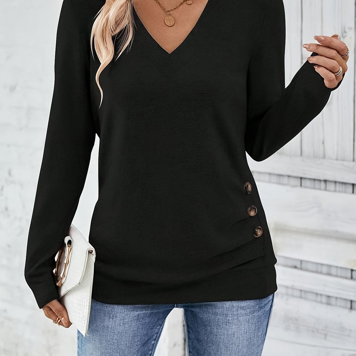 Black women’s V-neck long-sleeve sweater with button side detail, close-up