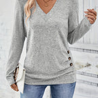 Light gray women’s V-neck long-sleeve sweater with button side detail