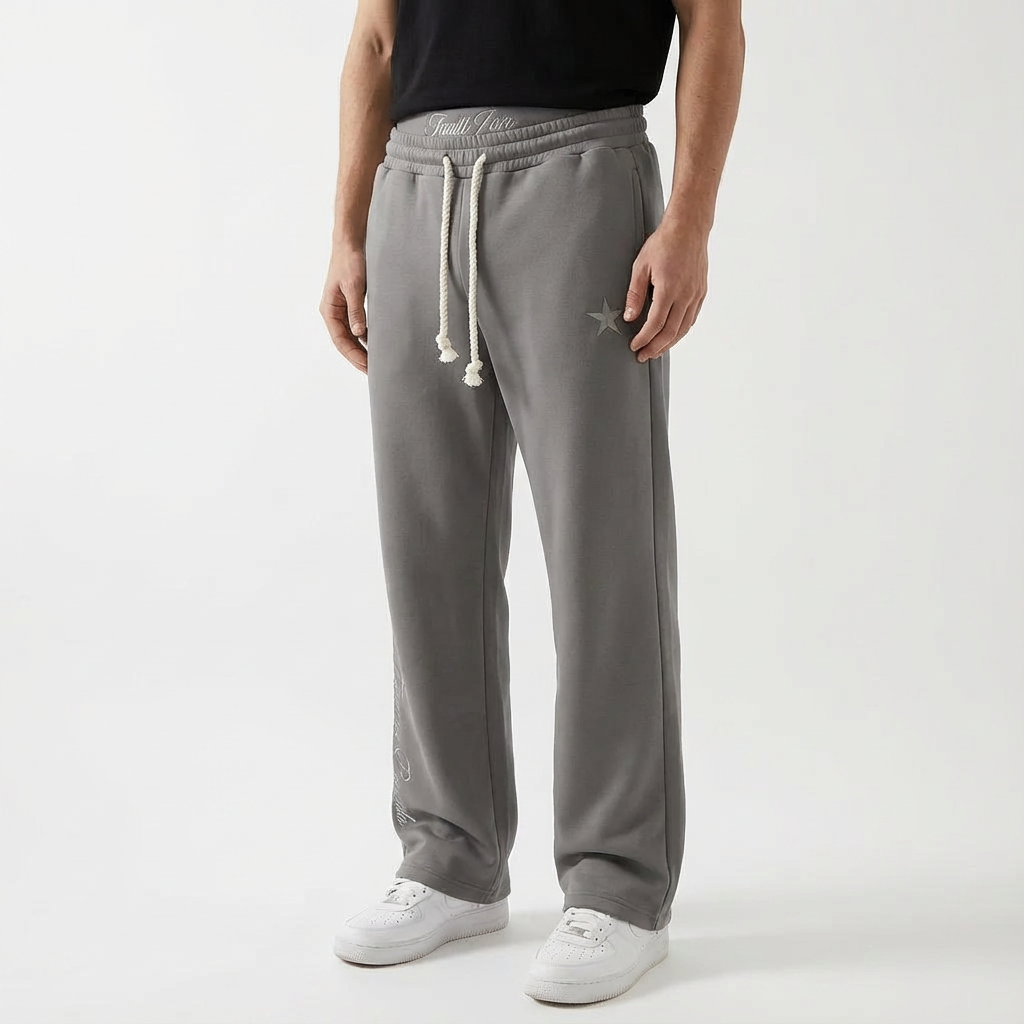 Unisex baggy joggers in gray with drawstring waist, side pockets, and star detail