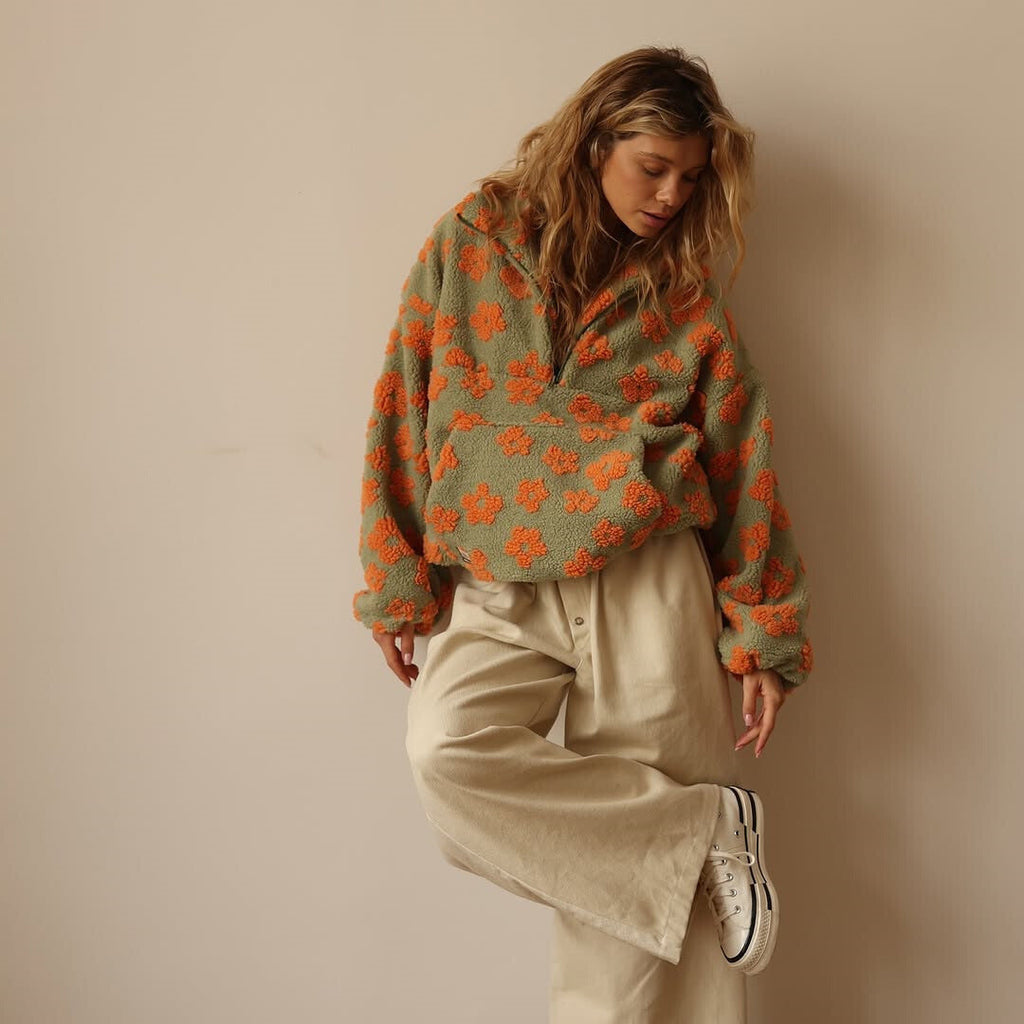 Women’s fuzzy quarter-zip sweater in green with orange floral print and zip-front