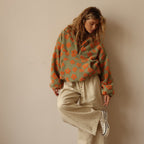 Women’s fuzzy quarter-zip sweater in green with orange floral print and zip-front