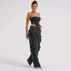 Black high-waist cargo jeans with relaxed fit and side utility pockets, ankle length.