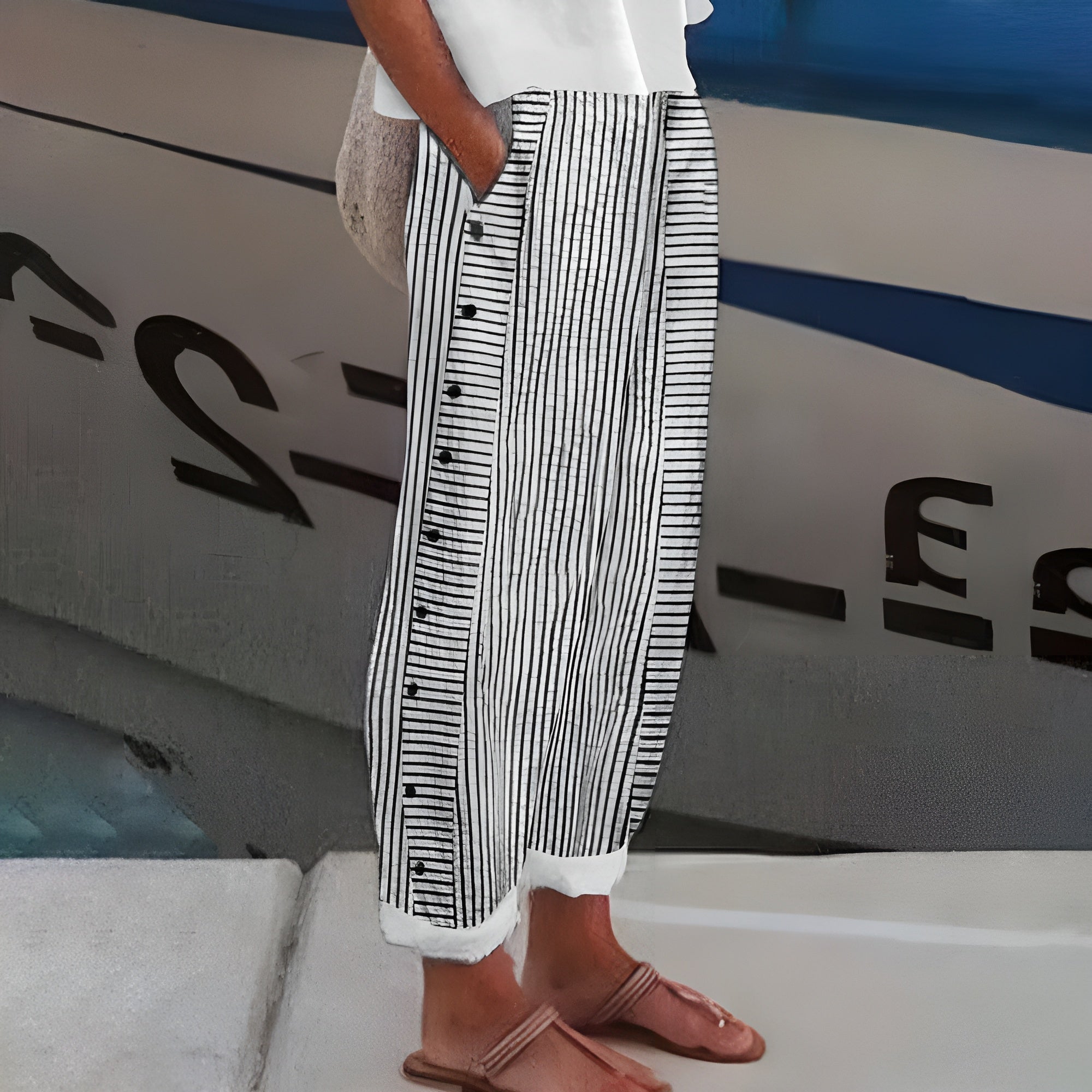 Striped wide-leg pants with black button placket, vertical stripe print