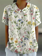 Floral print short-sleeve blouse in white with buttoned V-neck collar detail