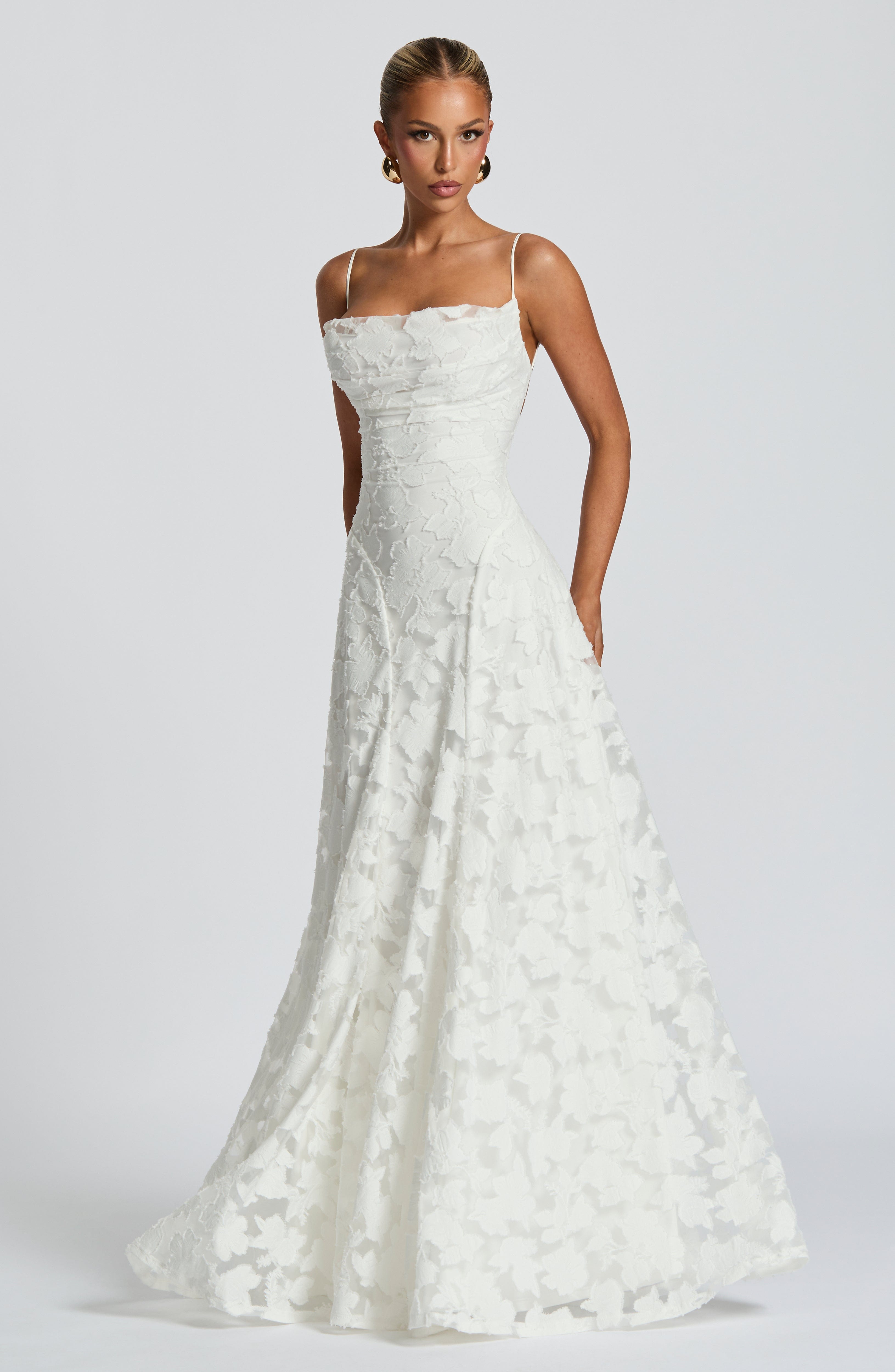 White maxi evening dress with spaghetti straps, fitted bodice, lace A-line skirt