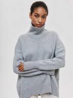 Gray knitted turtleneck sweater with long sleeves and ribbed hem detail