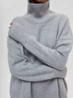 Light gray knitted turtleneck sweater with long sleeves and ribbed cuffs and hem