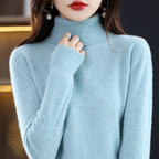 Women's cashmere turtleneck sweater in light blue, long sleeves, ribbed neckline and cuffs.