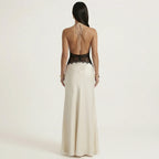 Cream backless halter maxi dress with black lace upper back and open tie straps.