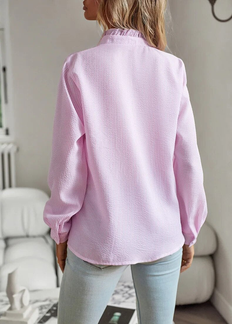 Light pink long-sleeve ruffle button-up blouse, back view with ruffled collar
