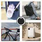 Round black GPS tracker attached to a keychain, shown in use on belongings