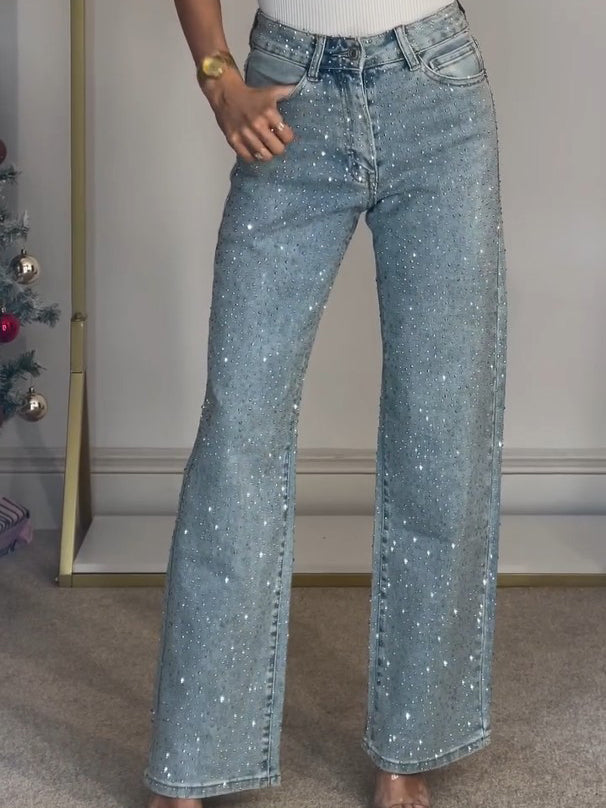 Light blue high-waist wide-leg jeans with subtle sparkle, front button and zipper.