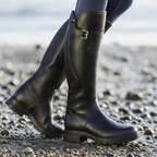 Knee-high black boots with side buckle strap and rugged lug sole