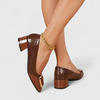 Women's brown croc-texture loafers with gold buckle and block heel, side view