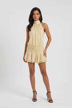 Women’s light yellow halter mini dress with high neckline, gathered waist, tiered hem