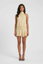 Women’s light yellow halter mini dress, sleeveless with smocked waist and ruffled bottom