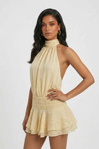 Women’s light yellow halter mini dress with high neck and tiered ruffle hem
