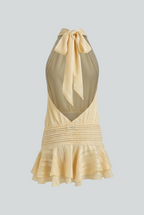 Light yellow women’s mini dress, open back with tie bow, smocked waist, ruffled hem