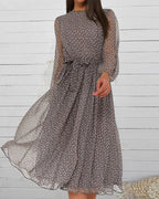 Grey polka dot A-line dress with long sheer sleeves, high neck, gathered waist bow