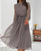 Grey polka dot knee-length A-line dress with long sheer sleeves and waist bow tie