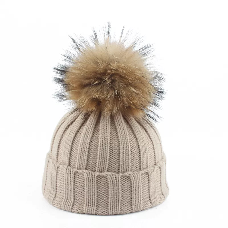 Knit beanie hat with tan pom-pom, ribbed texture, light taupe color