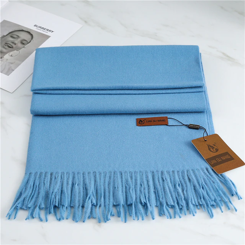 Light blue cashmere scarf with long fringes, folded
