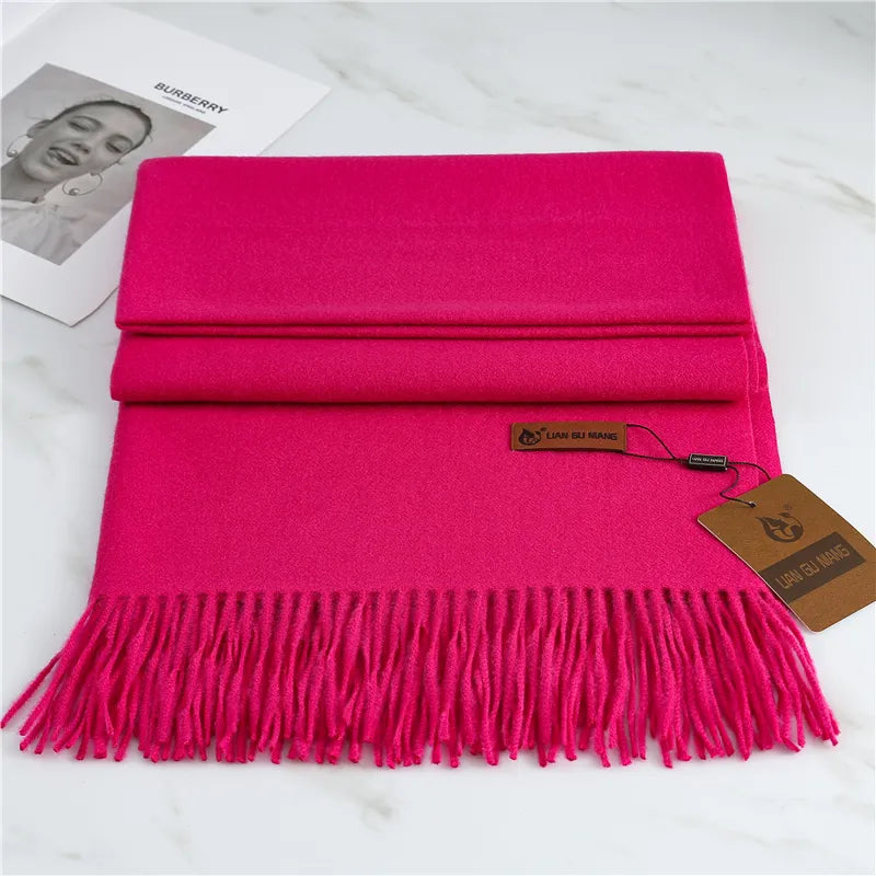 Bright pink cashmere scarf with long fringed ends and hanging tag