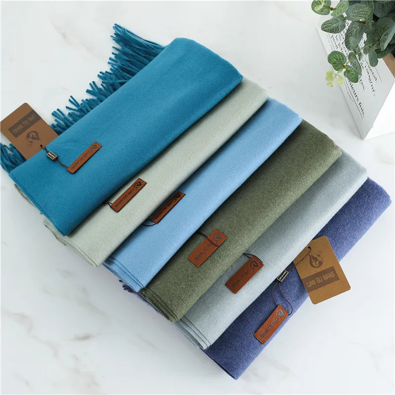 Sky blue cashmere scarf folded with long fringed ends