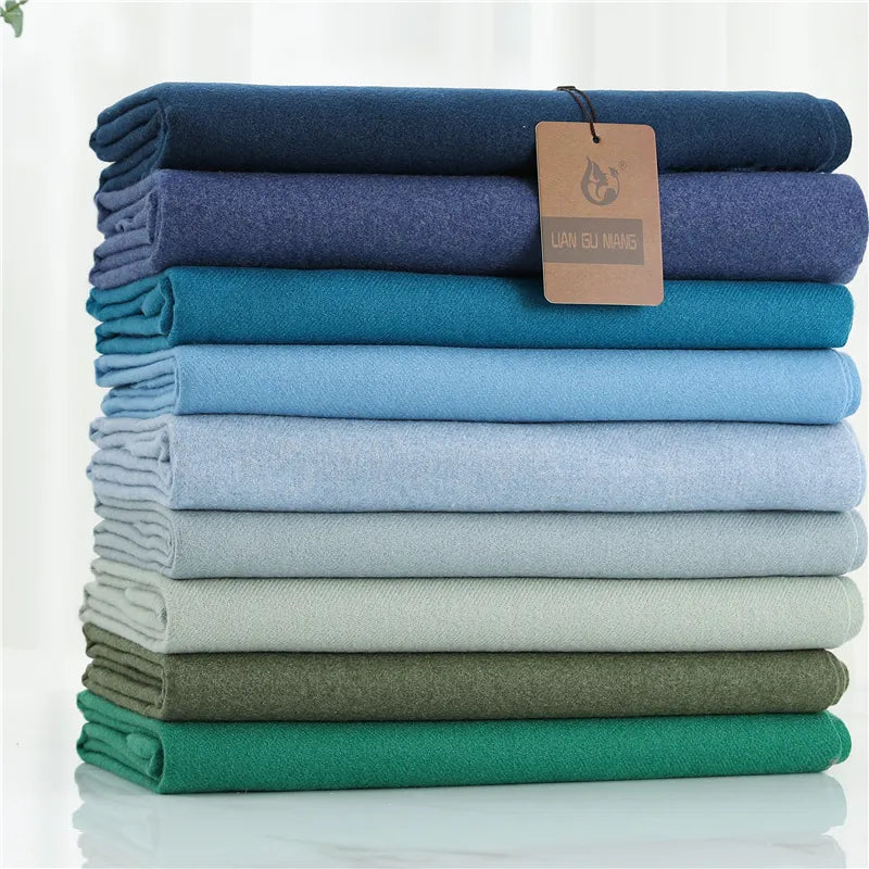 Folded blue cashmere scarf with fringed edge; hang tag attached