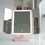 Pink LED makeup mirror on base with two side light panels and central display glass