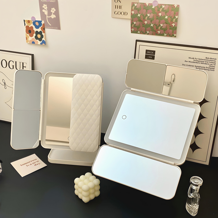 Triple-light LED makeup mirror with open screens and quilted back cover on stand