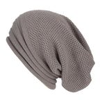 Light gray knitted beanie with ribbed fold-over cuff and textured stitch pattern