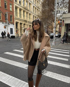 Light brown loose-fit women’s coat with wide lapels and button closure, standing pose.