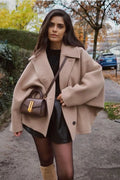 Women's loose-fit tan coat with large lapels and button front, long sleeves