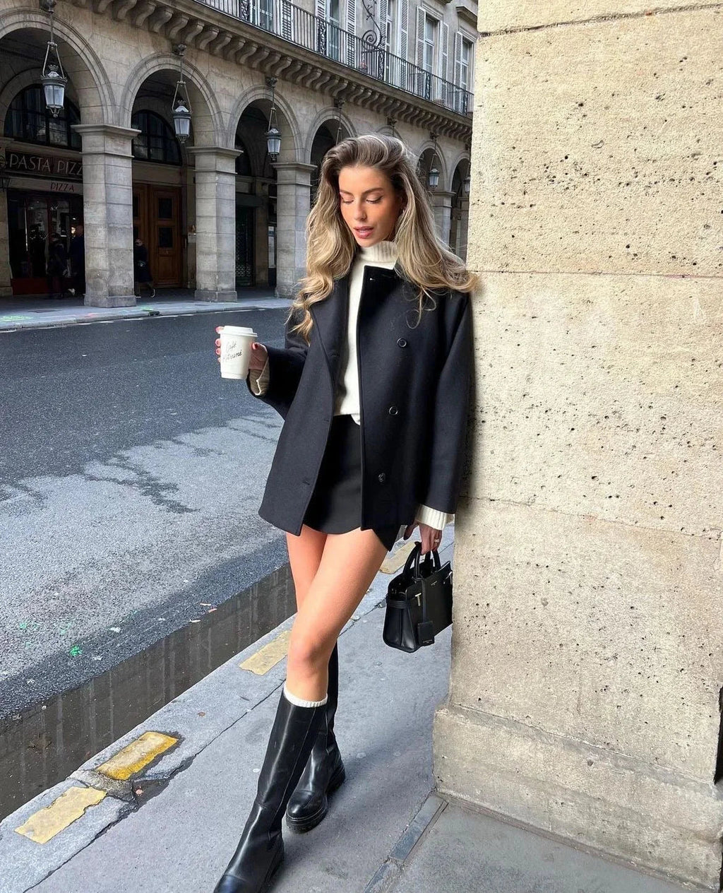 Black loose-fit women’s coat with wide lapels and two-button front, front view.