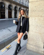 Black loose-fit women’s coat with wide lapels and two-button front, front view.
