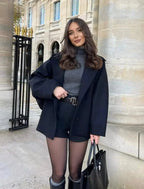 Women's loose-fit dark coat with large lapels and button front, long sleeves