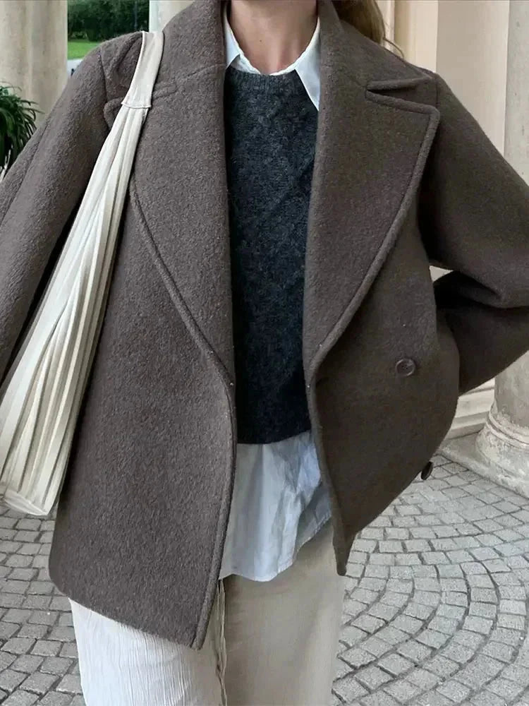 Women’s oversized brown coat with wide lapels, button front, and long sleeves