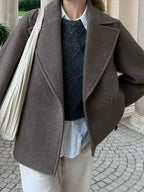 Women’s oversized brown coat with wide lapels, button front, and long sleeves