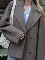 Women’s oversized brown coat with button-front closure and wide long sleeves
