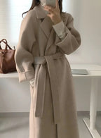 Long women's coat with belt and notched collar, light beige, long sleeves