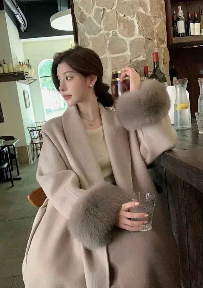 Long belted women’s coat with faux fur cuffs, light wrap V-neck