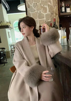 Long belted women’s coat with faux fur cuffs, light wrap V-neck