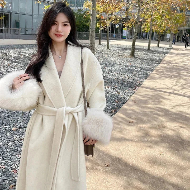 Long belted women’s coat with faux fur cuffs, off-white wrap V-neck