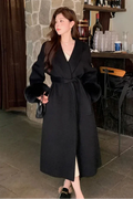 Long belted women’s coat with faux fur sleeves, black wrap V-neck