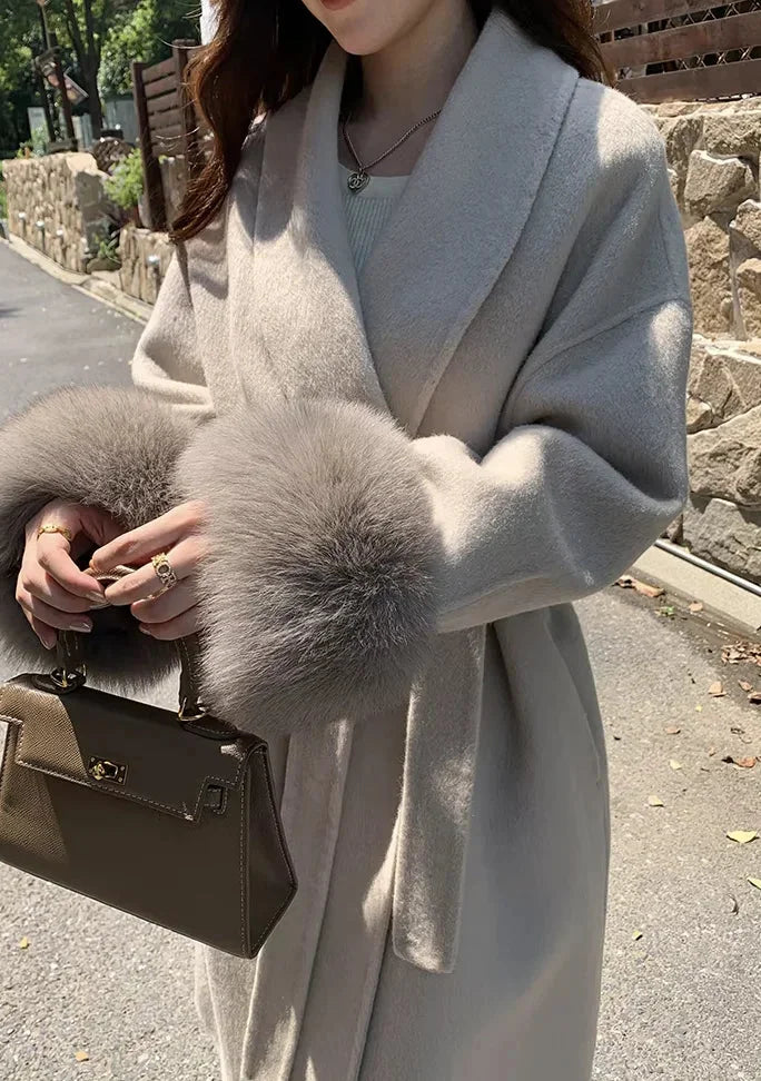 Long belted women’s coat with faux fur cuffs, light wrap V-neck