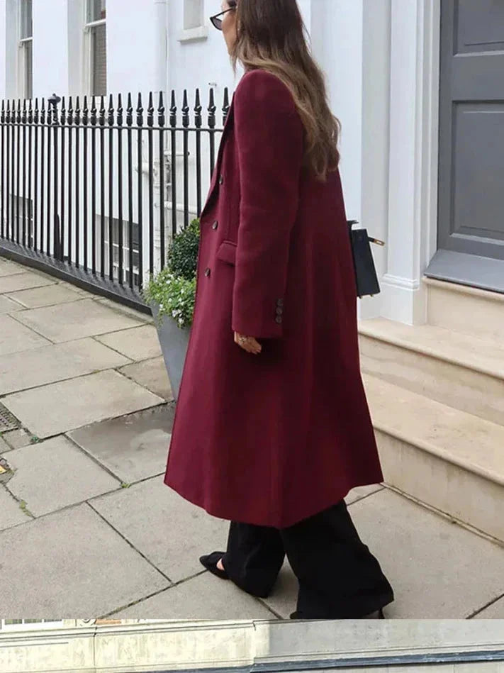 Burgundy long double-breasted coat with notched lapels and side button detail