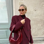 Burgundy long double-breasted coat with high notched collar and button closures