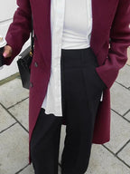 Burgundy long double-breasted coat with notched collar and button front